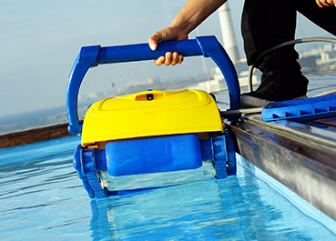 Automated pool cleaner being lifted from a pool